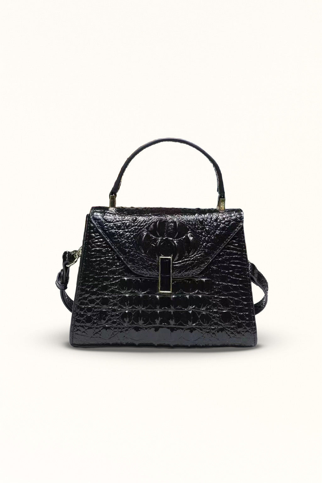 Black leather crossbody bag with a clamshell closure and lock accent