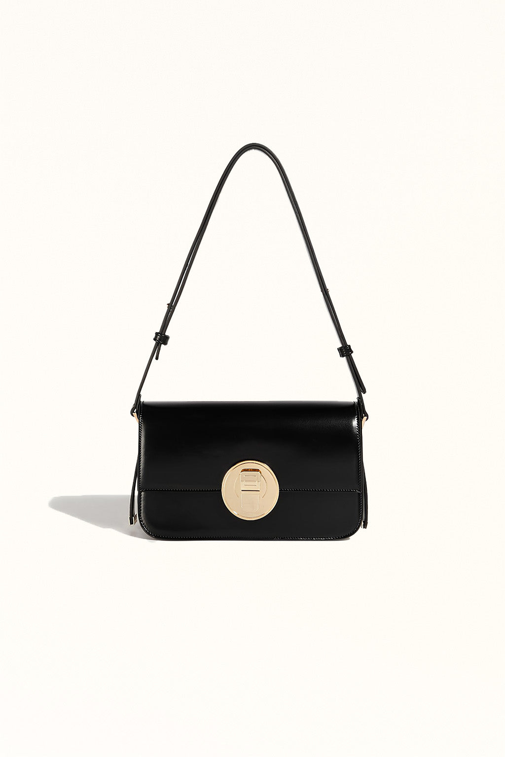 Black leather crossbody bag with structured square shape and secure lock