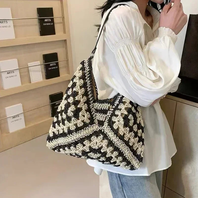 Woven black straw purse with sturdy strap and casual chic appeal