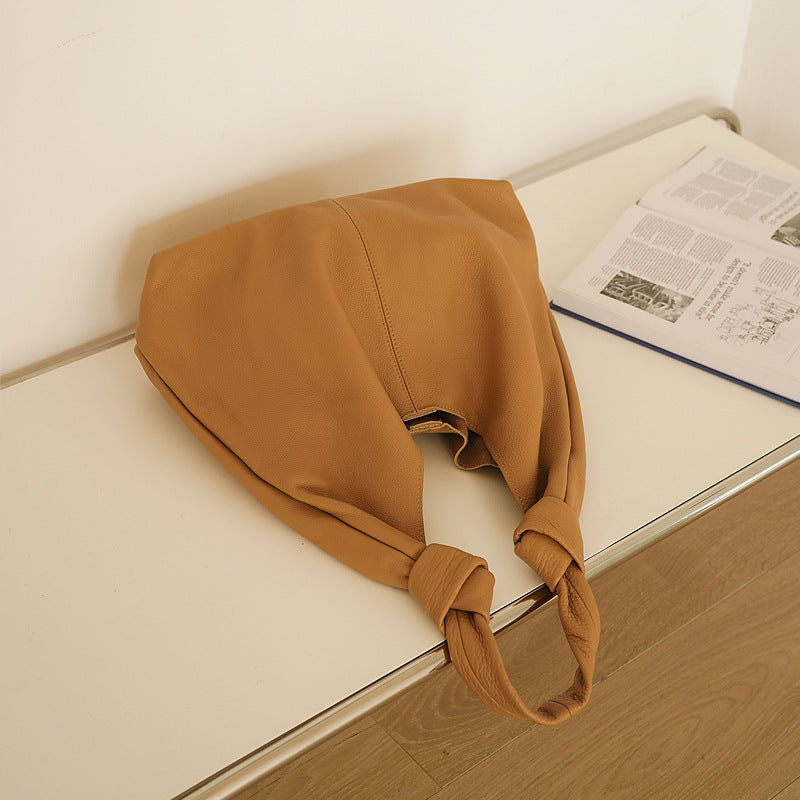 Genuine brown cowhide handbag with soft feel and urban simplicity design