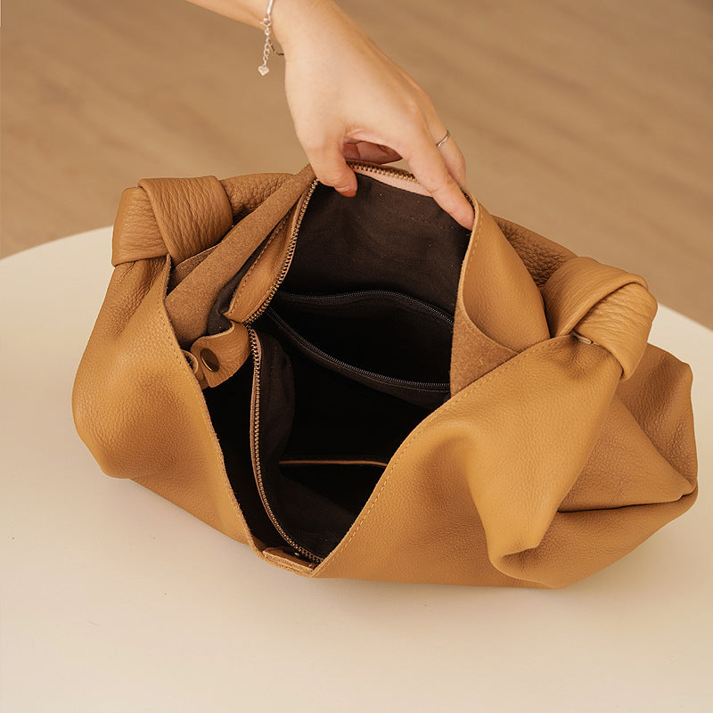 Genuine brown cowhide handbag with soft feel and urban simplicity design