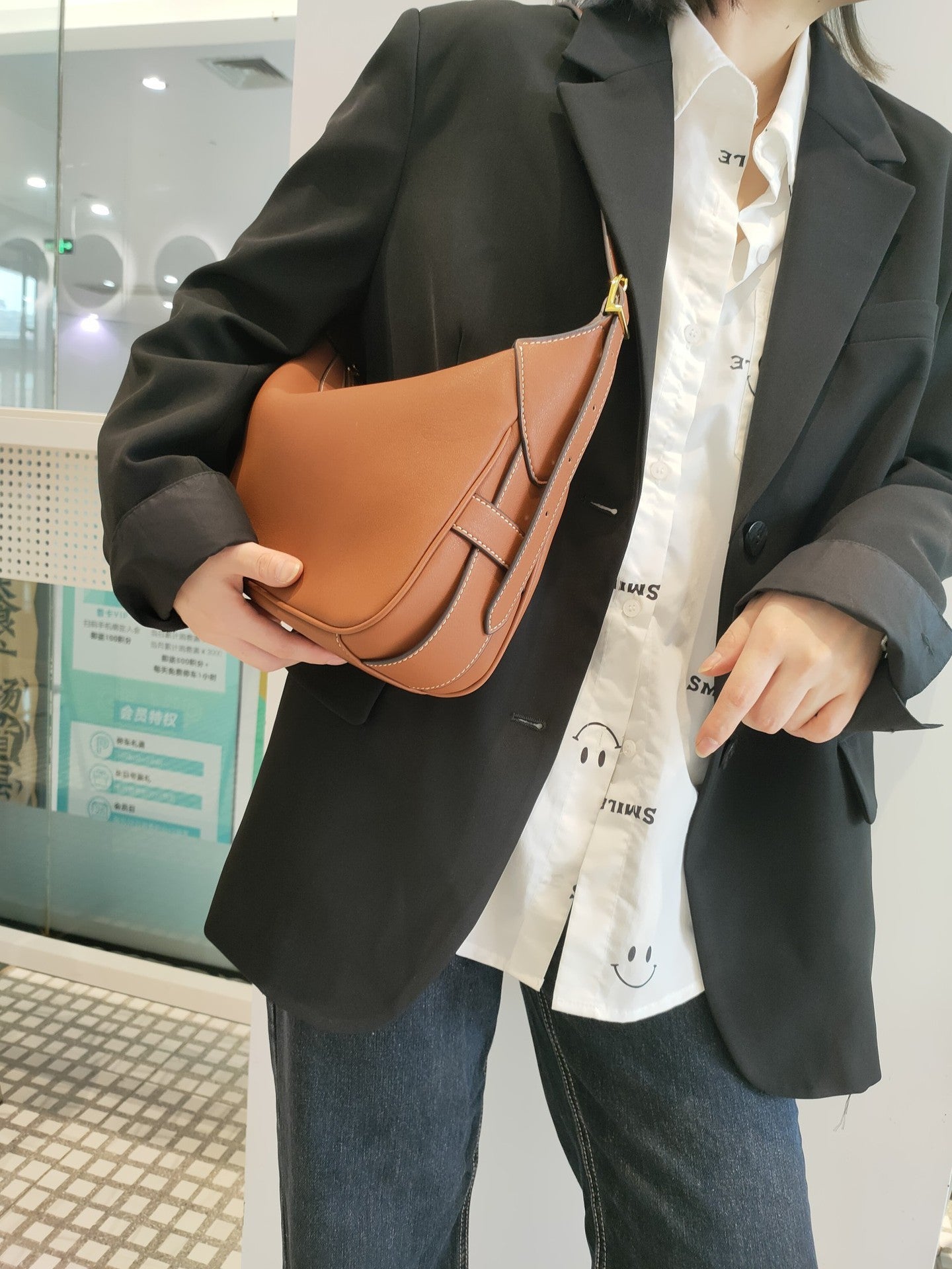 Leather shoulder bag with chain accent and soft cowhide texture