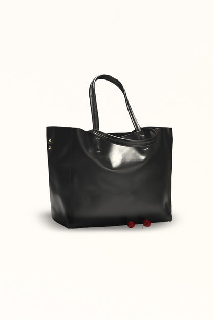 Black leather handbag with soft texture and versatile carry options