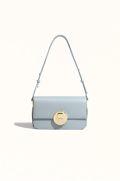 Light blue cowhide messenger bag with lock closure and square shape